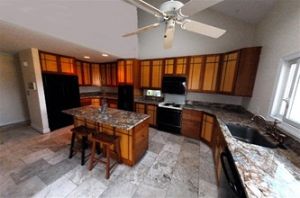 Custom designed cabinets complimented by granite tops and lime stone floors